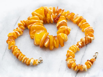 A long graduated single-strand butterscotch amber bead necklace, beads  ranging from 28.1mm to 9.8mm,