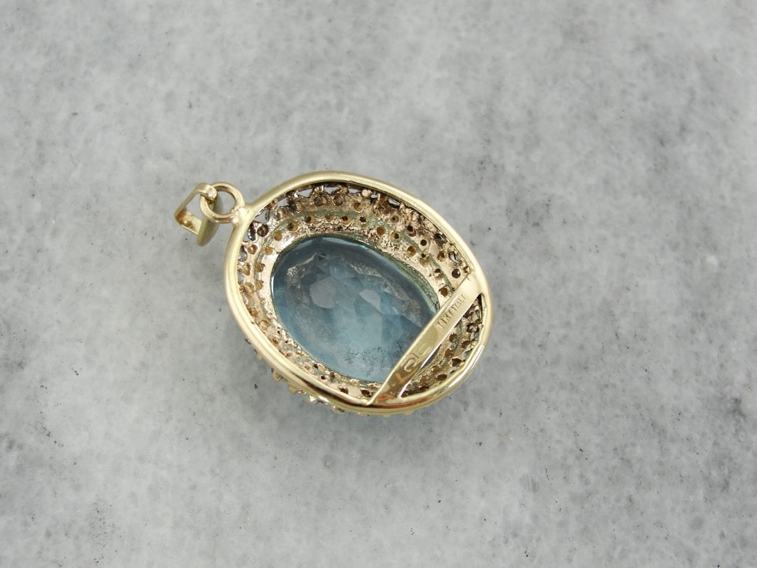 Stunning Blue Topaz Pendant with Diamond Halo in Two Tone Gold