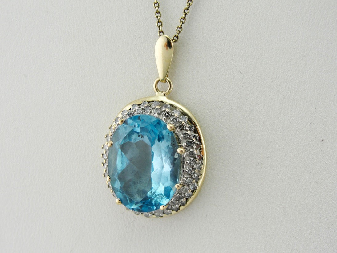 Stunning Blue Topaz Pendant with Diamond Halo in Two Tone Gold