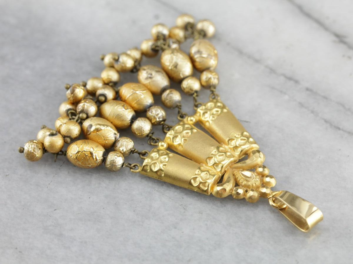 Colgante de cuentas de oro de alto quilate y vidrio soplado