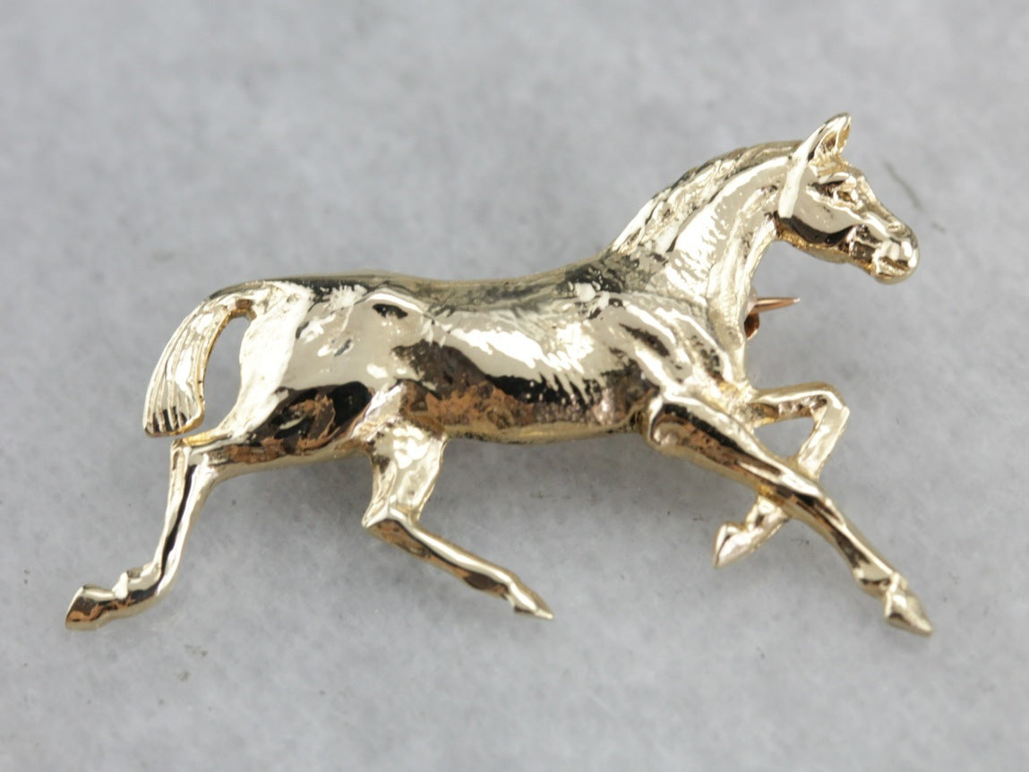 Golden Hooves: Galloping Horse Pin Crafted of Yellow Gold