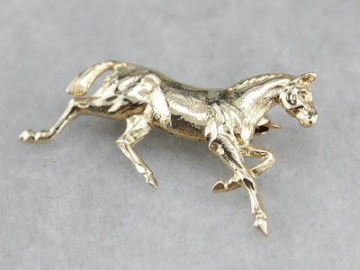 Golden Hooves: Galloping Horse Pin Crafted of Yellow Gold