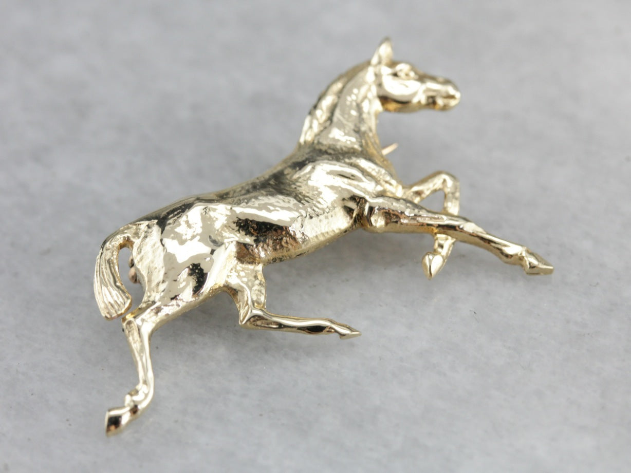 Golden Hooves: Galloping Horse Pin Crafted of Yellow Gold
