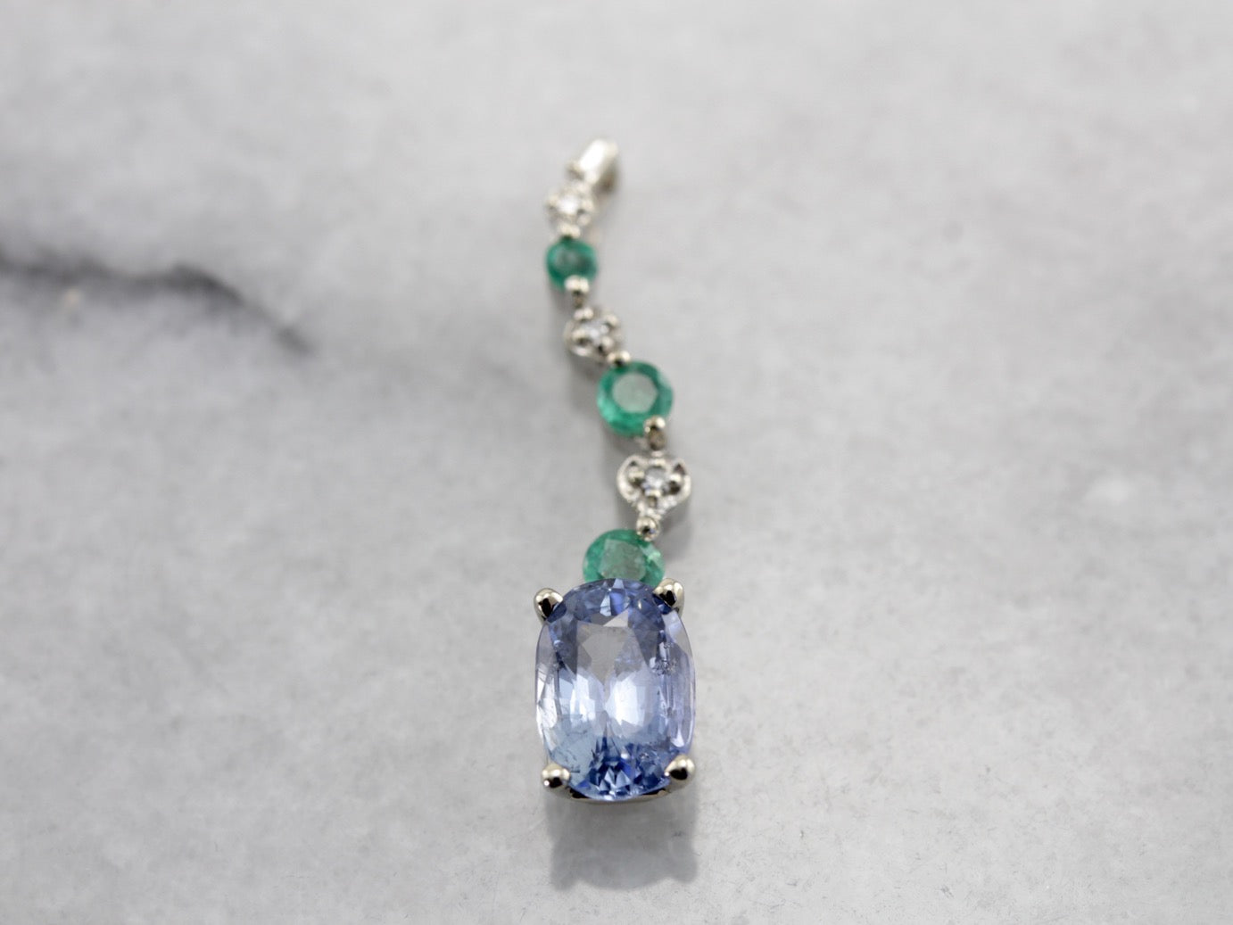 Unusual Pale Blue Sapphire, Emerald and Diamond Accented Pendant