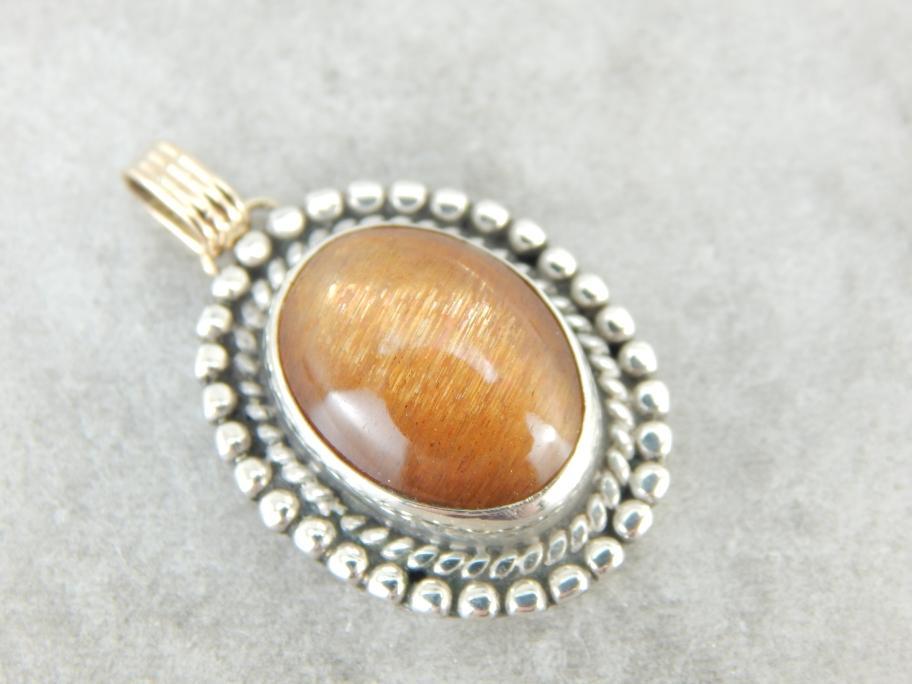 Glittering Orange Sunstone Pendant in Sterling and Gold Frame