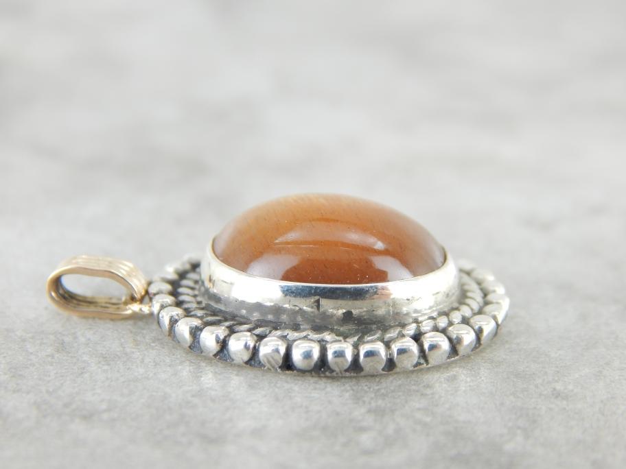 Glittering Orange Sunstone Pendant in Sterling and Gold Frame