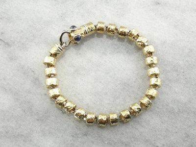 18 Karat Yellow Gold Bracelet with Faceted Links and Decorative Clasp