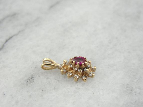Ruby and Diamond Halo Pendant in Yellow Gold