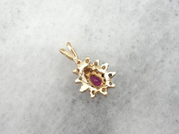 Ruby and Diamond Halo Pendant in Yellow Gold