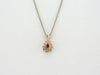 Ruby and Diamond Halo Pendant in Yellow Gold