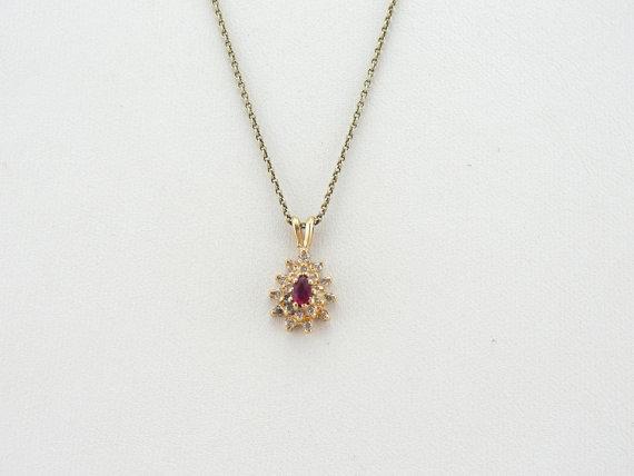 Ruby and Diamond Halo Pendant in Yellow Gold