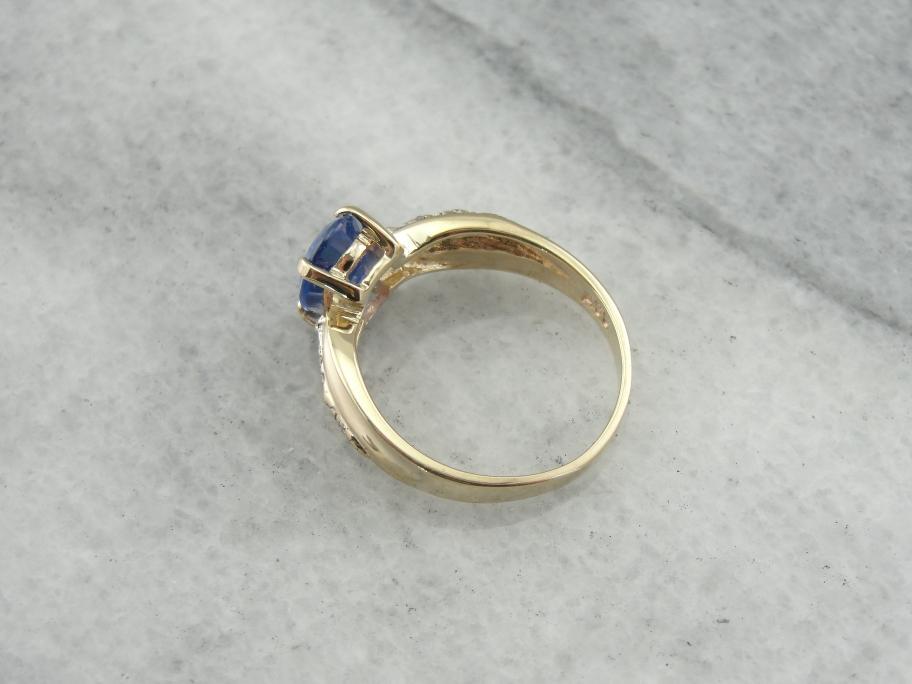 Twisting and Elegant Sapphire Ring with Diamond Accents